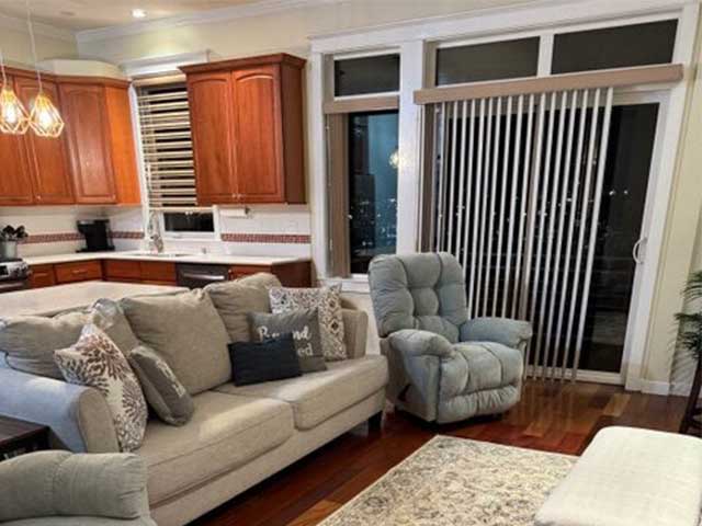 A living room with a couch and cleaned carpets