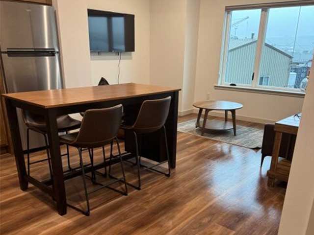 A cleaned kitchen with dark brown, wooden flooring
